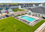 Thumbnail 52 of 58 - A swimming pool is surrounded by a fence in a grassy area.