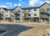 Thumbnail 39 of 44 - Apartment building number 57300 is shown with a parking lot in front.