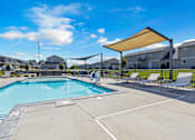 Thumbnail 47 of 81 - A large outdoor swimming pool with a sunshade.