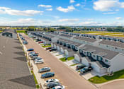 Thumbnail 56 of 58 - A row of houses with cars parked in front.