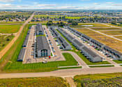 Thumbnail 53 of 58 - A large, well-maintained airport with multiple hangars and a runway.