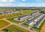 Thumbnail 55 of 58 - A large, well-maintained housing complex with multiple buildings and green spaces.
