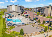 Thumbnail 50 of 81 - A large building with a pool in front of it.