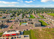 Thumbnail 30 of 57 - A view of a town from above with a large building in the foreground.