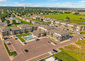 Thumbnail 31 of 57 - A large parking lot is surrounded by apartment buildings.