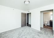 Thumbnail 8 of 19 - an empty room with a toilet and a door to a bathroom