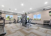 Thumbnail 8 of 31 - A spacious gym with a variety of equipment and a view of the outdoors through the windows.