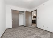 Thumbnail 26 of 31 - A room with a carpeted floor and two doors.