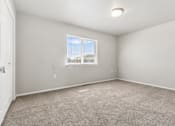 Thumbnail 8 of 26 - A room with a carpeted floor and a window.