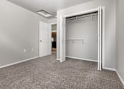 Thumbnail 15 of 26 - A room with a carpeted floor and a white door.