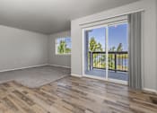 Thumbnail 6 of 26 - A room with a sliding glass door leading to a balcony.