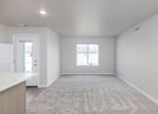 Thumbnail 12 of 26 - A spacious room with a carpeted floor and a window.