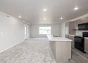 Thumbnail 17 of 26 - A spacious kitchen with a white countertop and wooden cabinets.