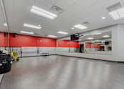 Thumbnail 47 of 54 - A large empty room with red walls and a grey floor.