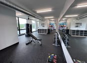 Thumbnail 7 of 81 - Modern gym with rows of cardio equipment.