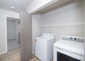 Thumbnail 4 of 22 - A small kitchen with a white oven and a white cabinet.