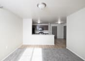 Thumbnail 8 of 22 - A white room with a grey carpet and a window.