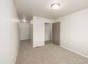 Thumbnail 16 of 22 - A room with a carpeted floor and a ceiling light.