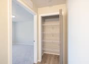 Thumbnail 15 of 22 - A white closet with a sliding door is open.