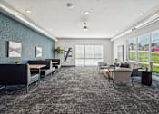 Thumbnail 16 of 21 - A spacious waiting room with grey carpeting and a variety of seating options.