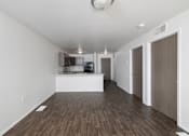 Thumbnail 14 of 50 - A spacious room with wooden flooring and white walls.