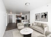 Thumbnail 3 of 50 - A living room with a couch, chair, and coffee table.