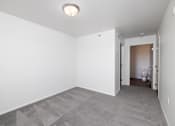 Thumbnail 21 of 50 - A room with a carpeted floor and a ceiling light.