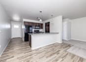 Thumbnail 11 of 26 - A kitchen area with a white countertop and wooden flooring.