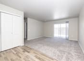 Thumbnail 20 of 26 - A room with a white door and a carpeted floor.