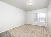 Thumbnail 22 of 26 - A room with a carpeted floor and a window.