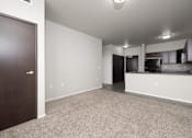 Thumbnail 24 of 26 - A room with a brown door and a carpeted floor.