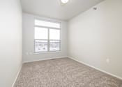 Thumbnail 2 of 26 - A room with a carpeted floor and a window.
