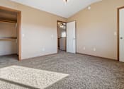 Thumbnail 51 of 64 - A room with a carpeted floor and a white door.