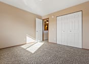 Thumbnail 21 of 64 - A room with a carpeted floor and two white doors.