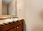 Thumbnail 58 of 64 - A bathroom with a sink and a mirror.