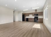 Thumbnail 2 of 32 - A spacious kitchen with wooden floors and modern appliances.