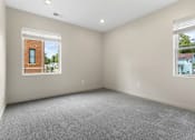 Thumbnail 6 of 32 - A room with a window showing a brick building outside.