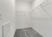 Thumbnail 7 of 32 - A white wall with a wire shelf and a vent.