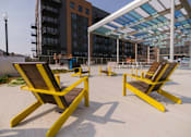 Thumbnail 34 of 41 - Two yellow chairs are placed on a concrete floor.