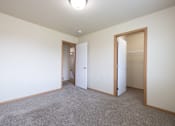 Thumbnail 20 of 22 - A room with a carpeted floor and two open doors.