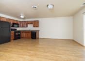 Thumbnail 13 of 22 - A kitchen with black appliances and wooden cabinets.