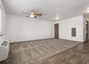 Thumbnail 51 of 59 - A room with a ceiling fan and a carpet on the floor.