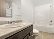 Thumbnail 56 of 59 - A bathroom with a sink, toilet, and bathtub.