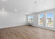 Thumbnail 35 of 44 - an empty living room with white walls and wood floors