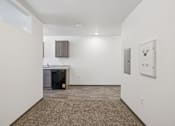 Thumbnail 19 of 21 - A room with a brown carpet and white walls.