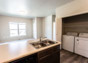 Thumbnail 6 of 24 - looking at living room and laundy room from kitchen