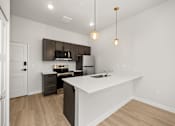 Thumbnail 31 of 42 - A kitchen with a white counter top and brown cabinets.