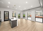 Thumbnail 5 of 42 - A spacious kitchen with a large island and a view of the city.