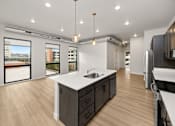 Thumbnail 38 of 42 - A modern kitchen with a large island and wooden floors.