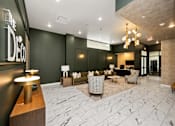 Thumbnail 16 of 42 - A reception area with a black sofa and a gold table.